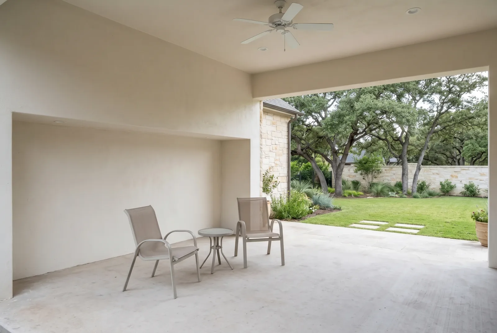 The same patio before the renovation: plain, with a basic ceiling fan (concept rendering)